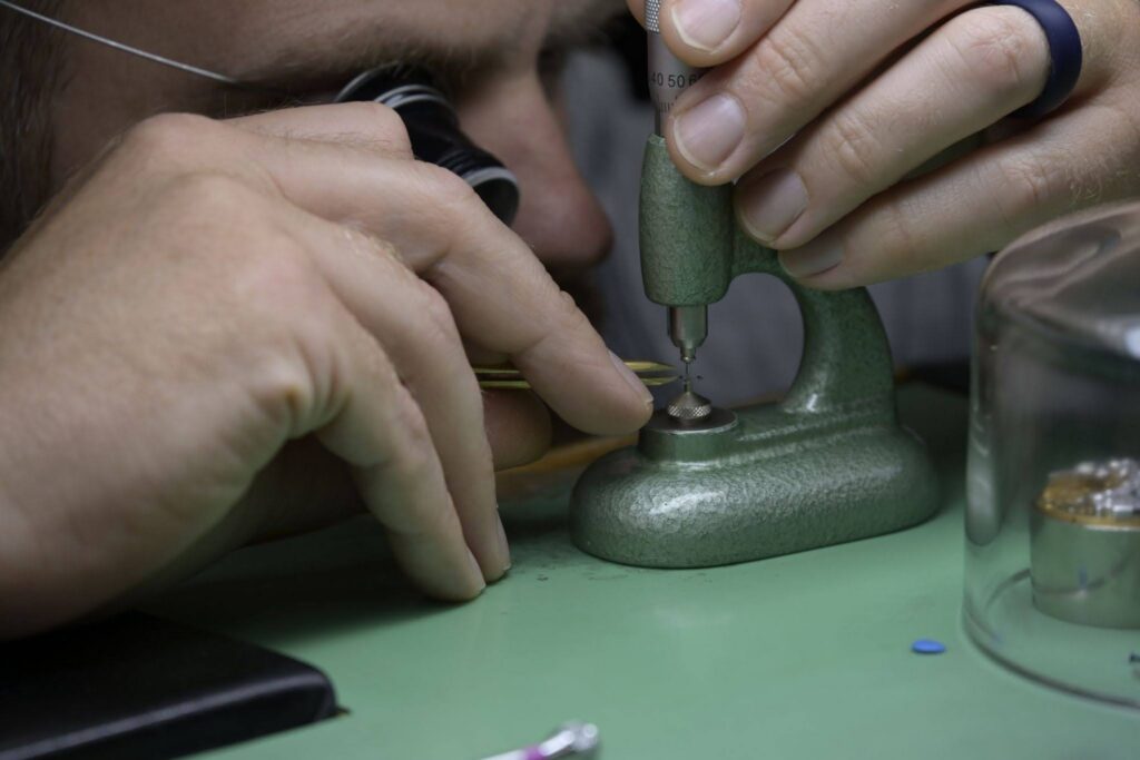 Engine-turning worked by hand in the RGM workshop. All of the brand's guilloché is executed in-house.